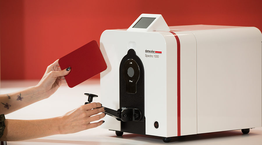 Hands inserting a sample into a Datacolor Spectro 1000 spectrophotometer.